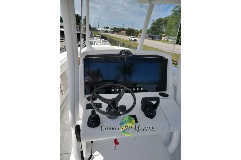 Slide: The Image of 2026 Jupiter 30 boat helm with steering wheel and navigation screens. - 24