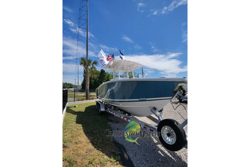 Slide: The Image of 2026 Jupiter 30 boat on trailer under clear blue sky, displayed outdoors. - 3