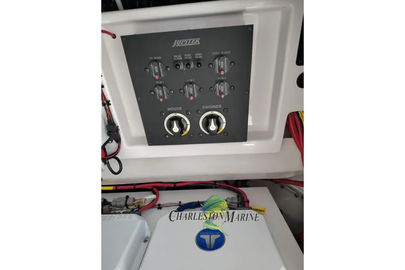 Slide: The Image of Control panel of a 2026 Jupiter 30 boat with switches and wiring. - 31