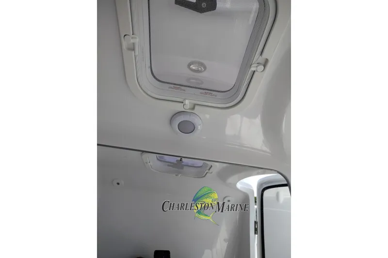 Slide: The Image of Interior view of 2026 Jupiter 30 boat cabin with hatch and Charleston Marine logo. - 36