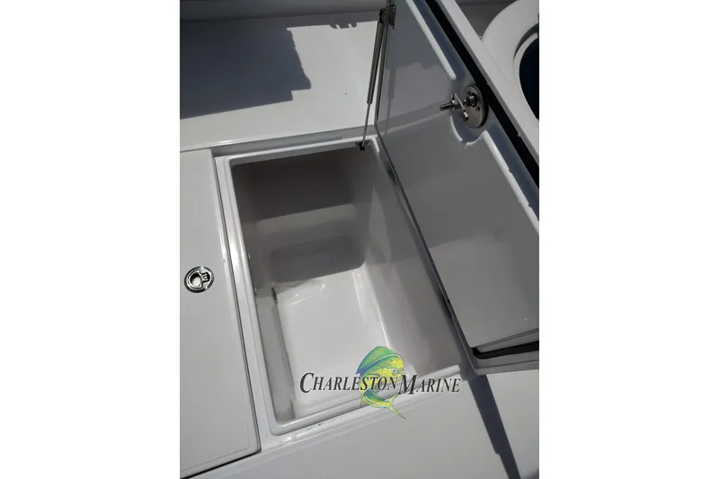 Slide: The Image of Open storage compartment on a 2026 Jupiter 30 boat, featuring Charleston Marine branding. - 37