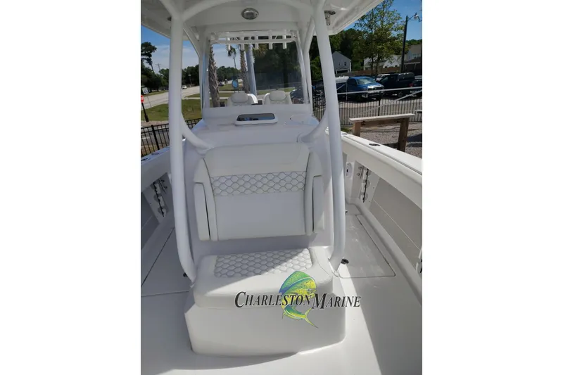 Slide: The Image of 2026 Jupiter 30 boat interior with white seating and Charleston Marine logo. - 9