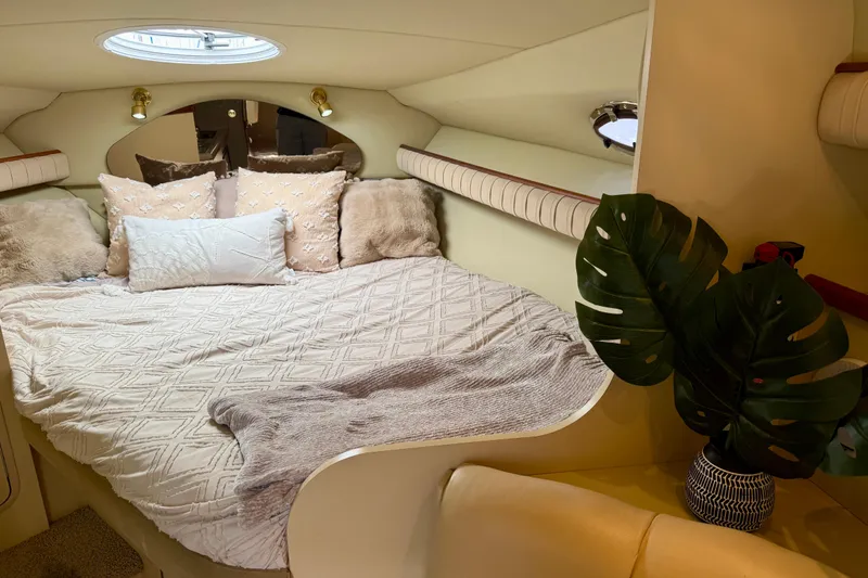 Slide: The Image of Cozy cabin interior of 2002 Cruisers Yachts 2870 Express with plush bedding and decorative plant. - 15