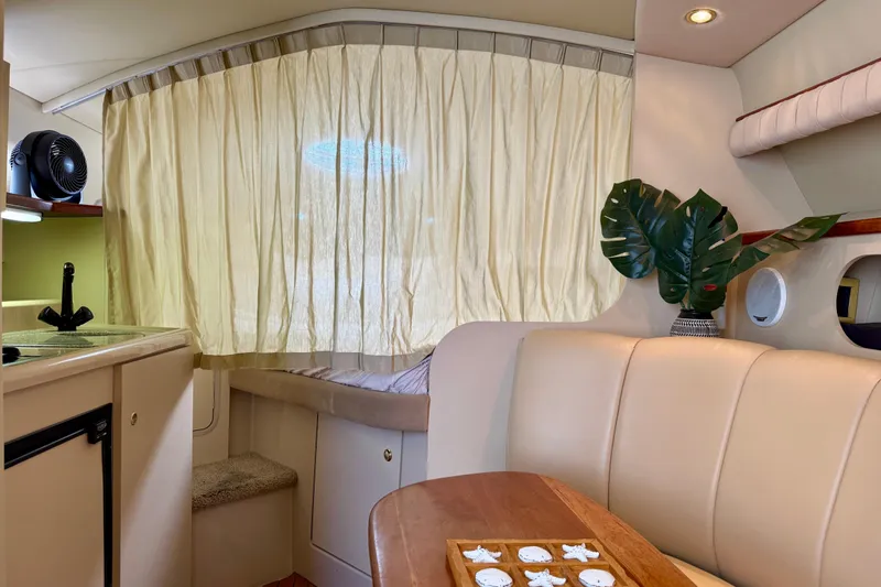 Slide: The Image of Interior of 2002 Cruisers Yachts 2870 Express with seating, table, and kitchenette. - 16