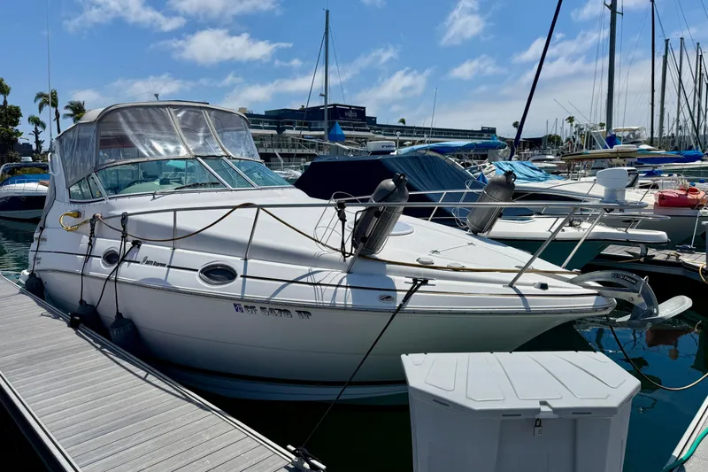 Slide: The Image of 2002 Cruisers Yachts 2870 Express docked at marina under clear blue sky. - 2