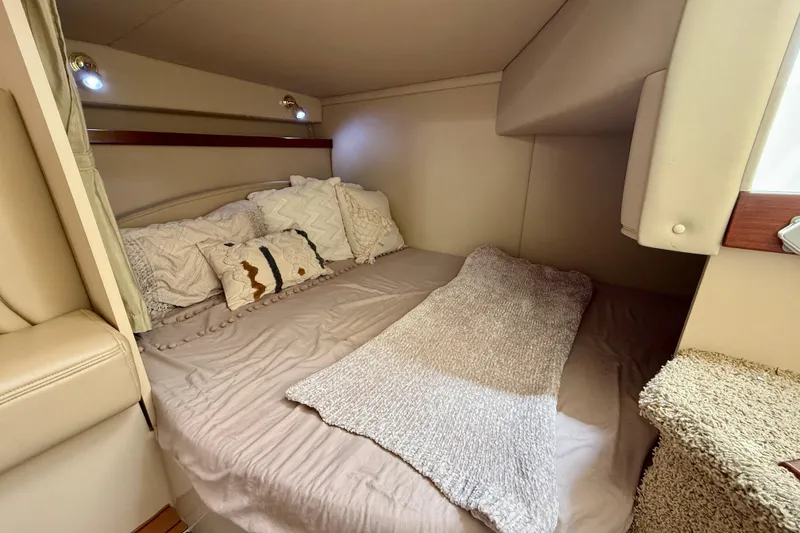 Slide: The Image of Cozy cabin interior of 2002 Cruisers Yachts 2870 Express with plush bedding. - 22