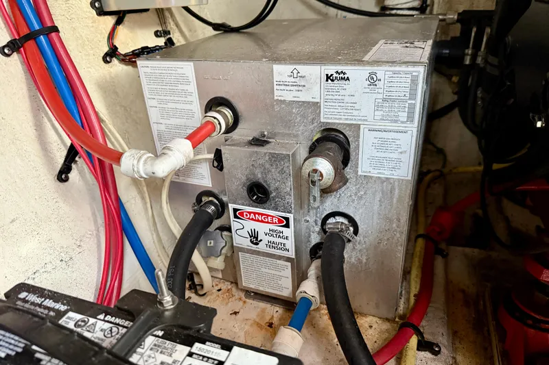 Slide: The Image of Engine compartment of a 2002 Cruisers Yachts 2870 Express, featuring electrical and plumbing components. - 35