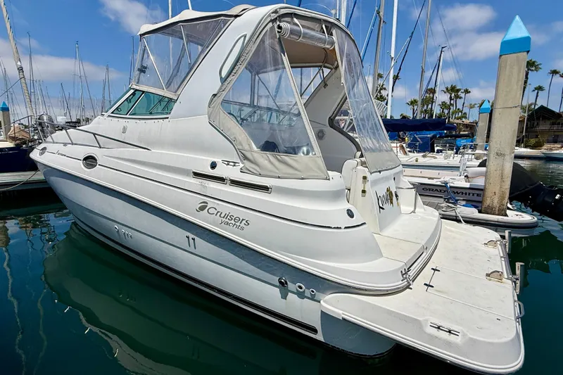 Slide: The Image of 2002 Cruisers Yachts 2870 Express docked in a marina, showcasing sleek design. - 4