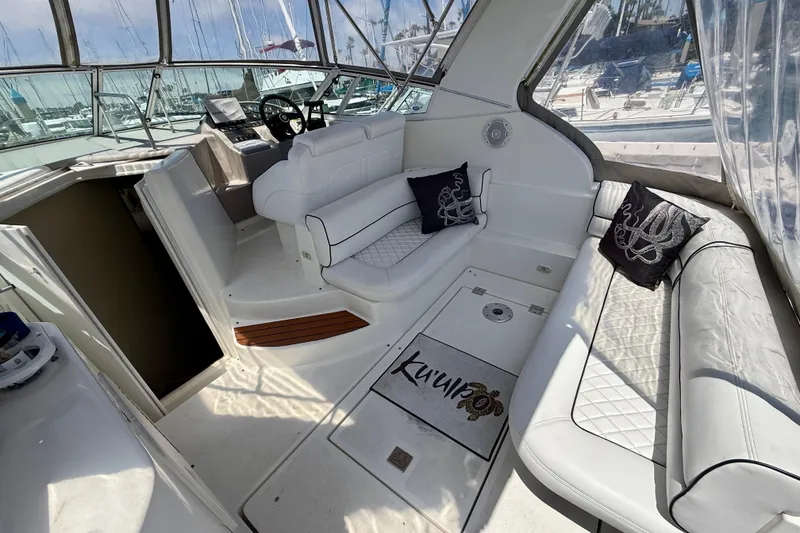 Slide: The Image of 2002 Cruisers Yachts 2870 Express interior with white seating and nautical decor. - 6