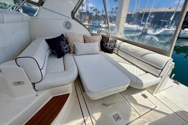 Slide: The Image of Luxurious seating area on a 2002 Cruisers Yachts 2870 Express, featuring plush white cushions. - 8