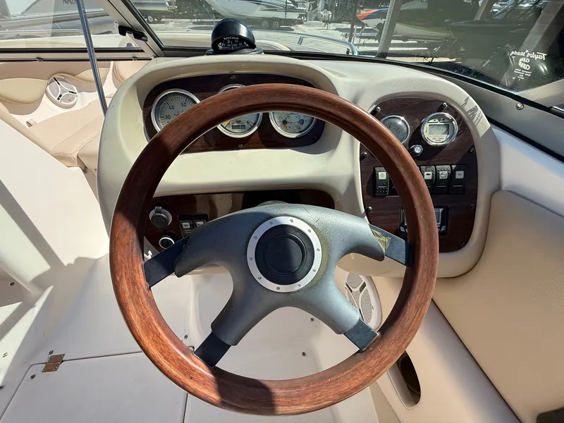 Slide: The Image of 2006 Chaparral SSi 210 boat dashboard with wooden steering wheel. - 13