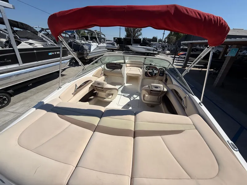 Slide: The Image of 2006 Chaparral SSi 210 boat with red sunshade and beige interior. - 9