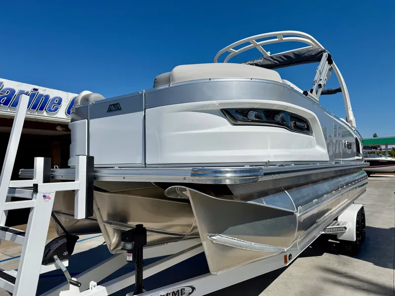 Slide: The Image of 2026 Avalon Excalibur LTD Flex Lounge boat on trailer. - 2