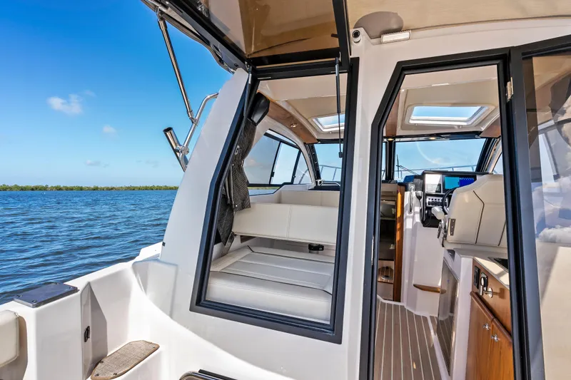 Slide: The Image of Interior view of 2026 Solara S-250 Coupe boat, featuring modern seating and navigation controls. - 10