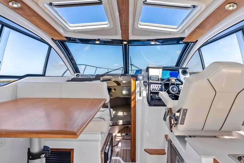 Slide: The Image of Interior of 2026 Solara S-250 Coupe boat with modern helm and seating area. - 12