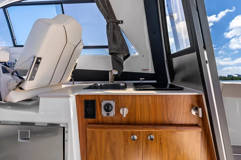 Slide: The Image of Interior of 2026 Solara S-250 Coupe featuring a compact kitchenette with sink and stove. - 15