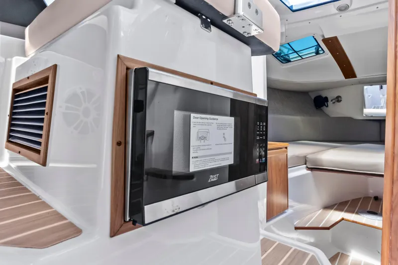 Slide: The Image of Interior of 2026 Solara S-250 Coupe featuring modern kitchenette and cozy seating area. - 17