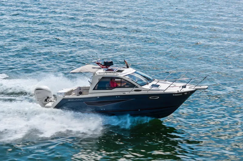 Slide: The Image of 2026 Solara S-250 Coupe cruising on open water, showcasing sleek design and performance. - 5