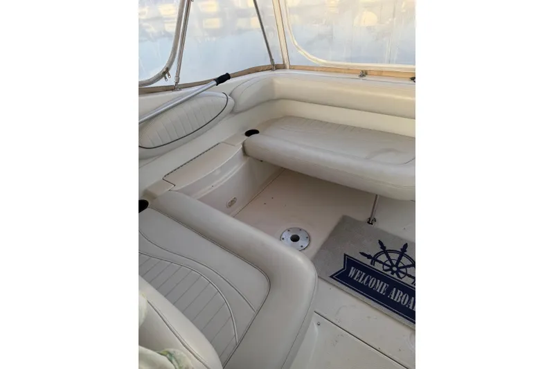 Slide: The Image of Interior of 2001 Maxum 2800 SCR boat with white seating and "Welcome Aboard" mat. - 4