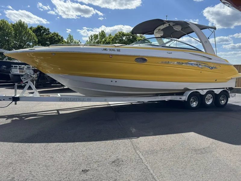 The Image of Yellow 2007 Crownline Bowrider 320 LS boat on trailer. - 1