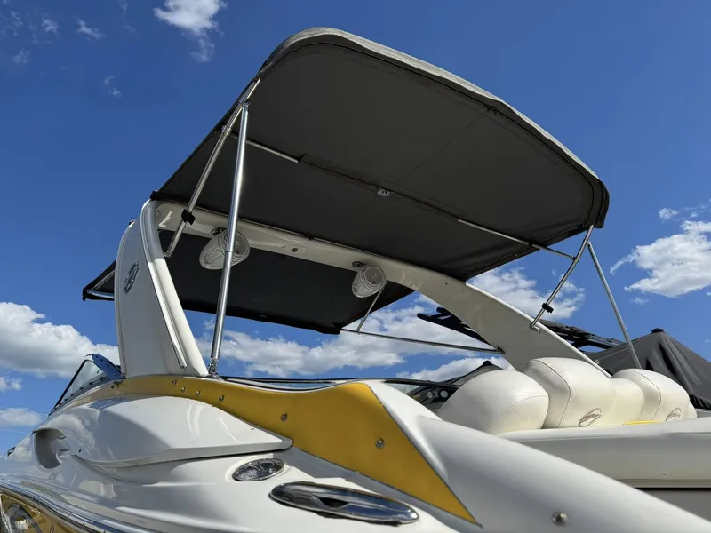 Slide: The Image of 2007 Crownline Bowrider 320 LS with sunshade against blue sky. - 15