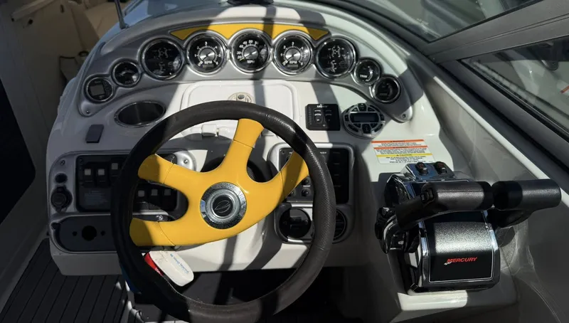 Slide: The Image of 2007 Crownline Bowrider 320 LS dashboard with yellow steering wheel. - 22