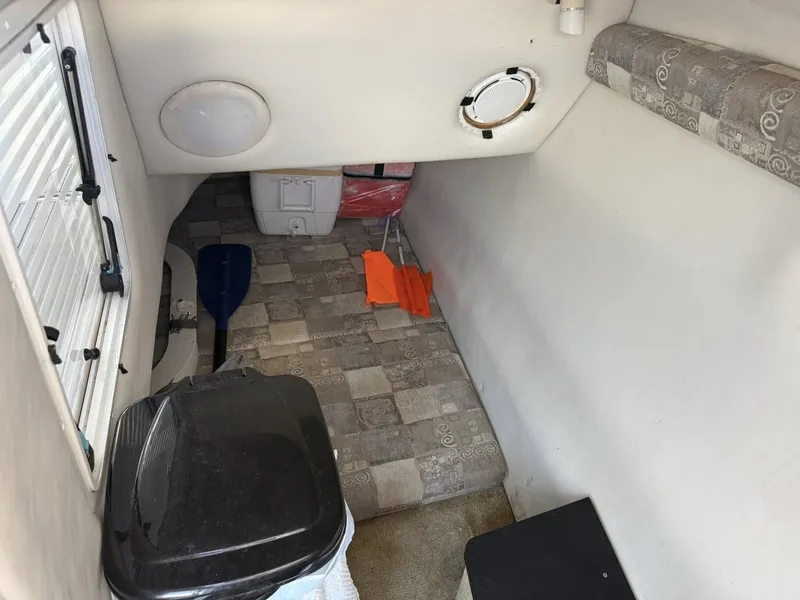 Slide: The Image of Interior of a 2007 Crownline Bowrider 320 LS boat with storage space. - 3