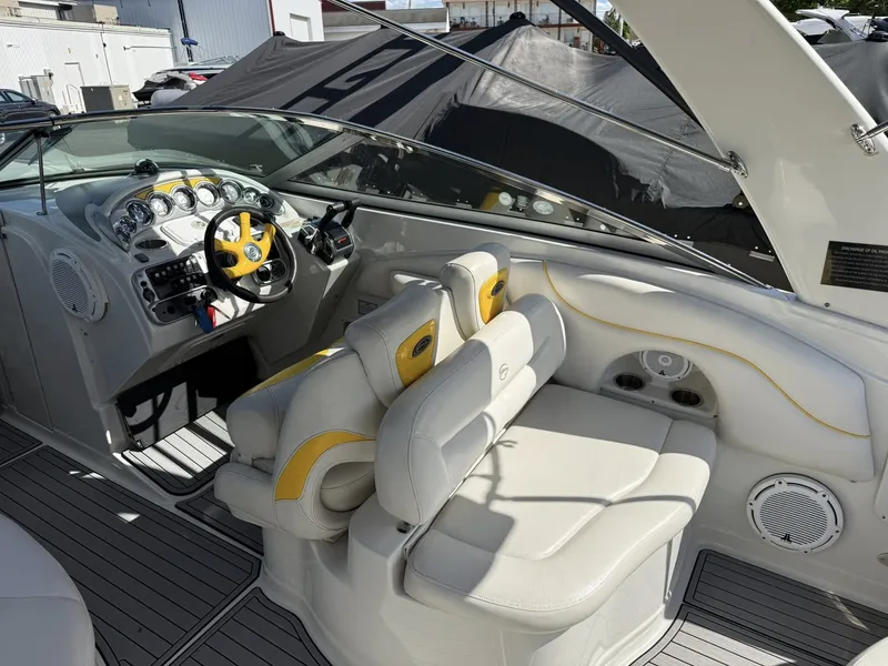 Slide: The Image of Interior of a 2007 Crownline Bowrider 320 LS with yellow accents. - 7