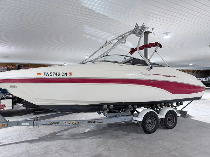 The Image of 2003 Rinker 232 Captiva boat on trailer in storage facility. - 1