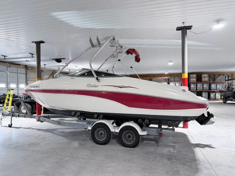 Slide: The Image of 2003 Rinker 232 Captiva boat on trailer in storage facility. - 11