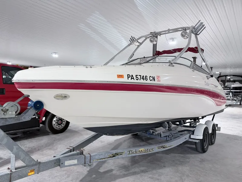 Slide: The Image of 2003 Rinker 232 Captiva boat on trailer in garage. - 13