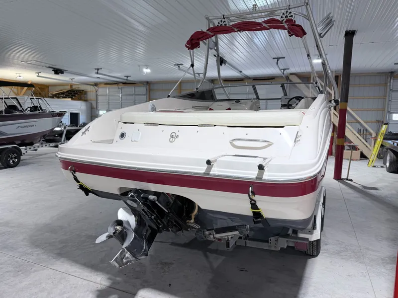 Slide: The Image of 2003 Rinker 232 Captiva boat parked in storage facility. - 15