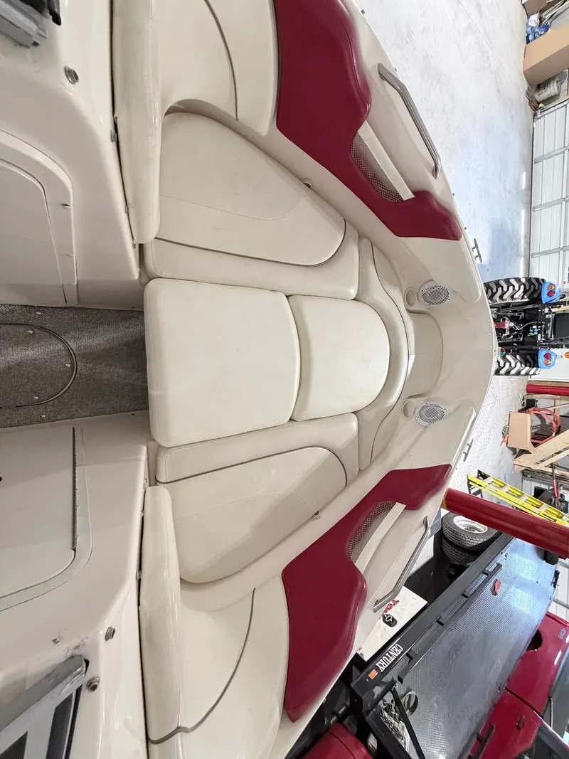 Slide: The Image of Interior of a 2003 Rinker 232 Captiva boat with red and white seating. - 17