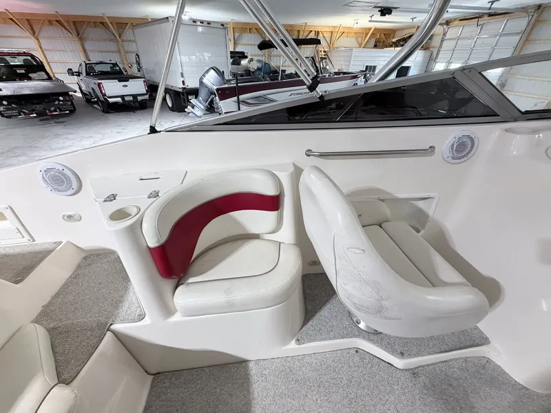 Slide: The Image of Interior of a 2003 Rinker 232 Captiva boat with white seating. - 19