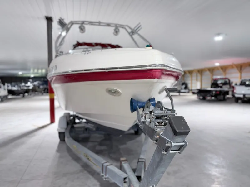 Slide: The Image of 2003 Rinker 232 Captiva boat on trailer in storage facility. - 2