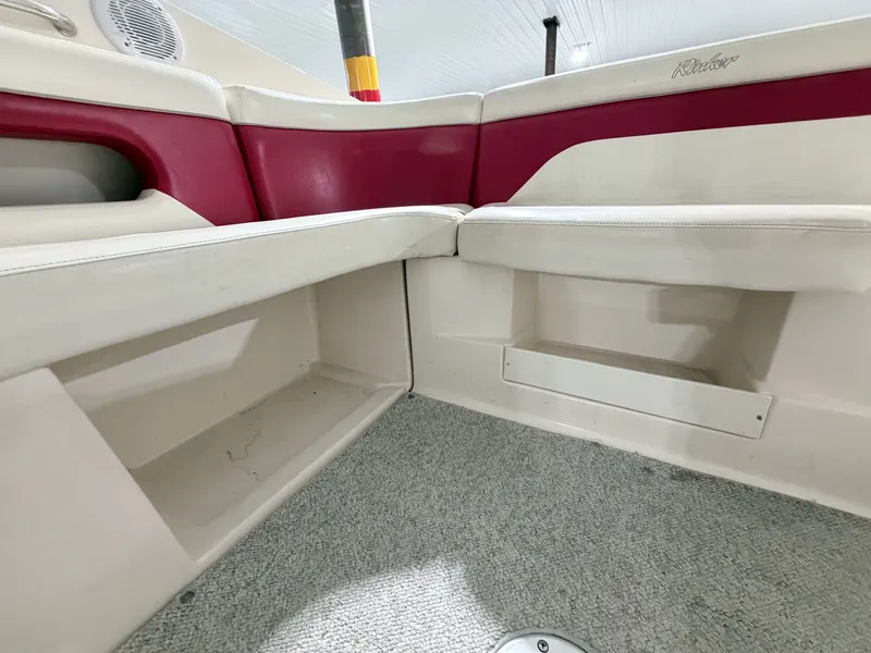 Slide: The Image of Interior of a 2003 Rinker 232 Captiva boat with red and white seating. - 20