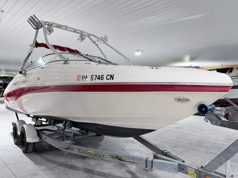Slide: The Image of 2003 Rinker 232 Captiva boat on trailer in storage facility. - 22