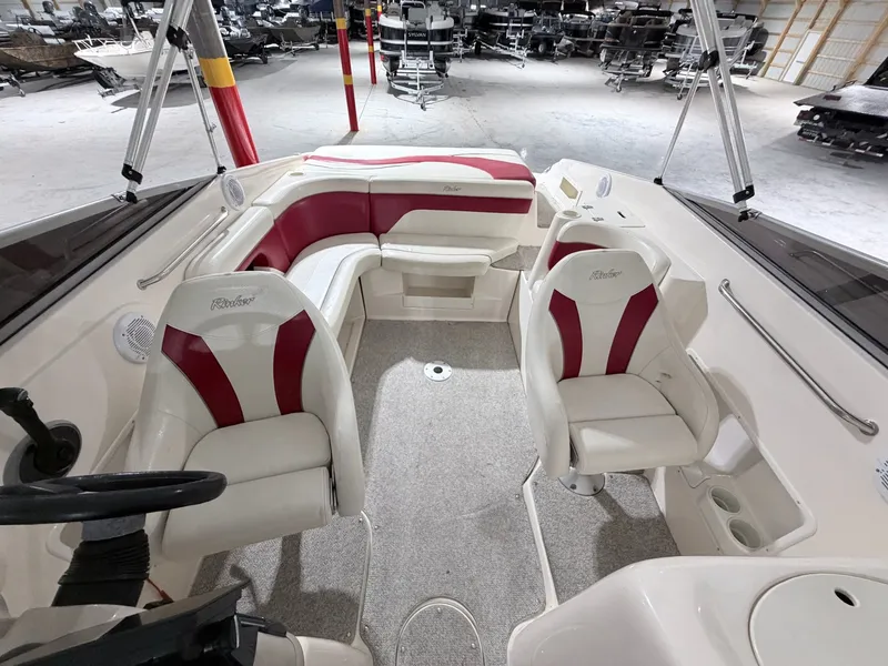 Slide: The Image of Interior of a 2003 Rinker 232 Captiva boat with red and white seating. - 23