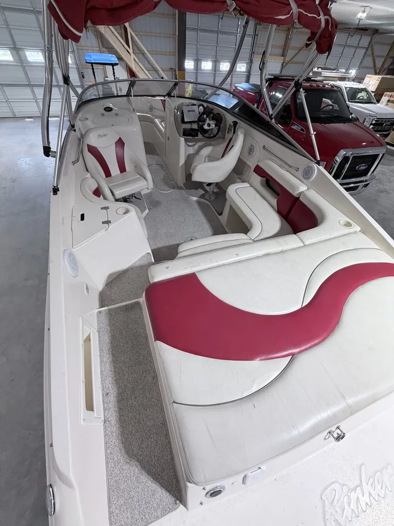 Slide: The Image of Interior of a 2003 Rinker 232 Captiva boat with red and white seating. - 24