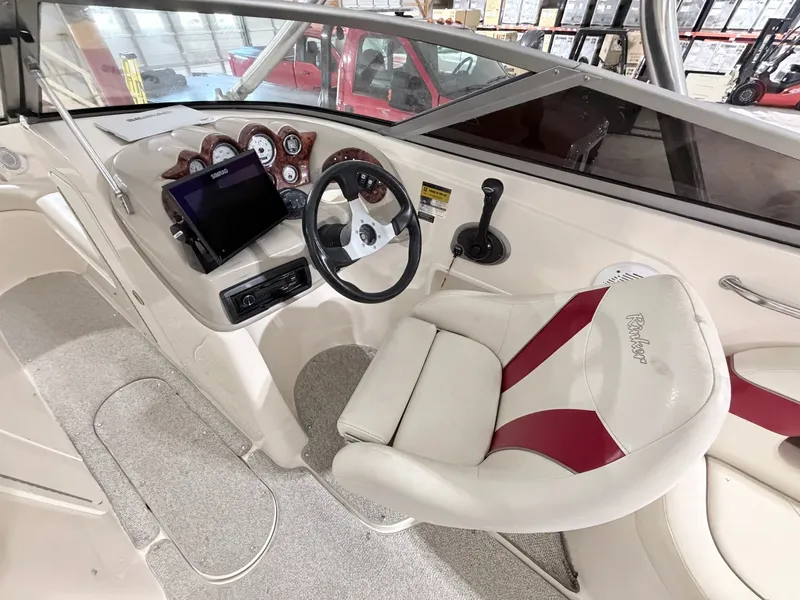 Slide: The Image of Interior view of a 2003 Rinker 232 Captiva boat with steering console. - 29
