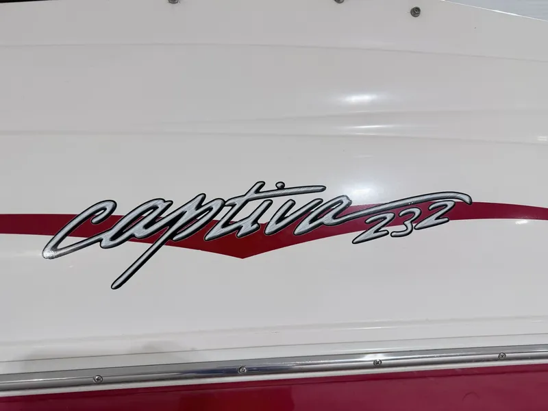 Slide: The Image of Rinker 232 Captiva boat logo, 2003 model, on white background. - 3