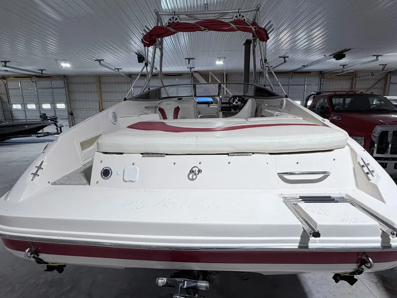 Slide: The Image of 2003 Rinker 232 Captiva boat in a garage. - 4