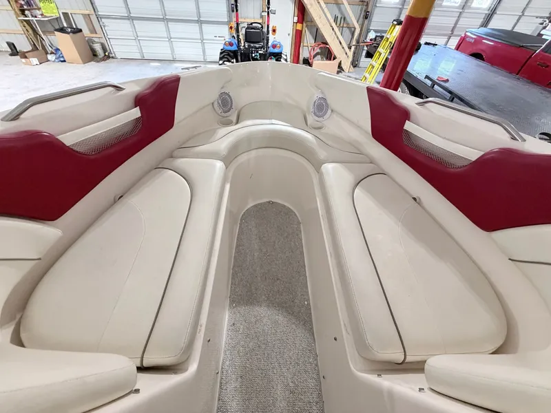 Slide: The Image of Interior of a 2003 Rinker 232 Captiva boat with red accents. - 5