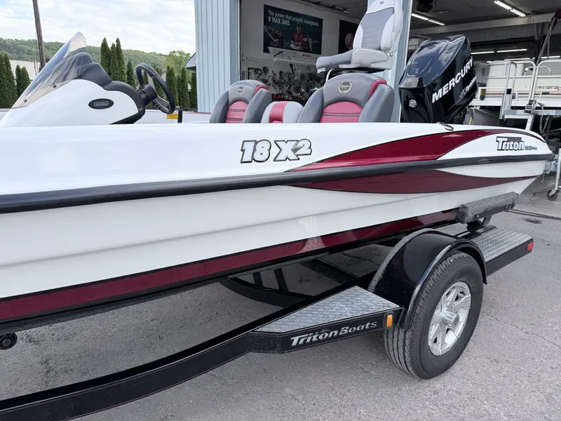 Slide: The Image of 2008 Triton 18X2 boat with Mercury engine on trailer. - 12