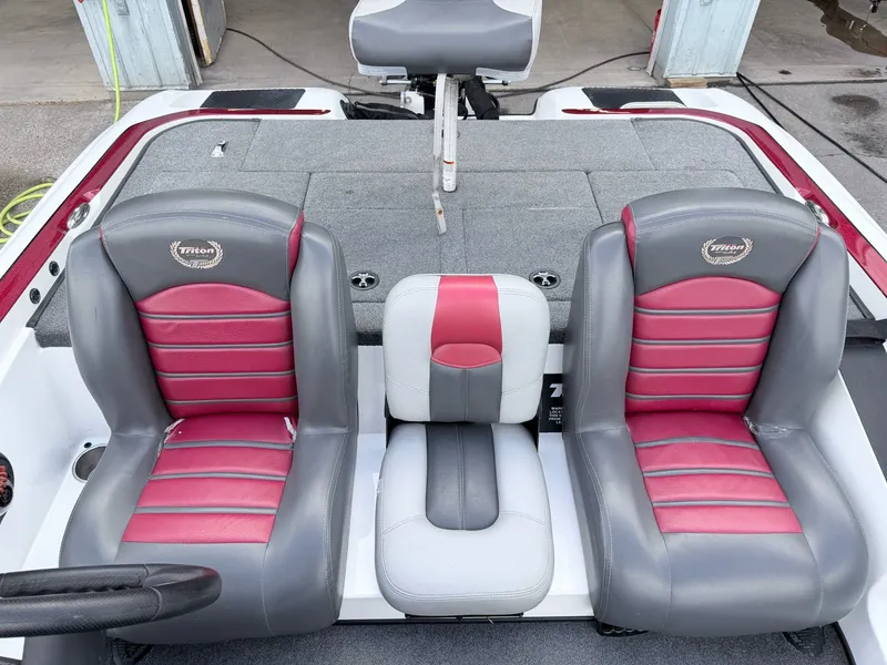 Slide: The Image of 2008 Triton 18X2 boat seats in gray and red. - 13
