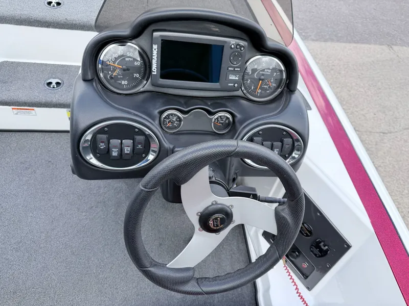 Slide: The Image of Dashboard of a 2008 Triton 18X2 boat with steering wheel and instruments. - 14