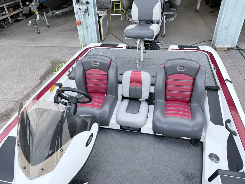 Slide: The Image of Interior of a 2008 Triton 18X2 boat with gray and red seats. - 22