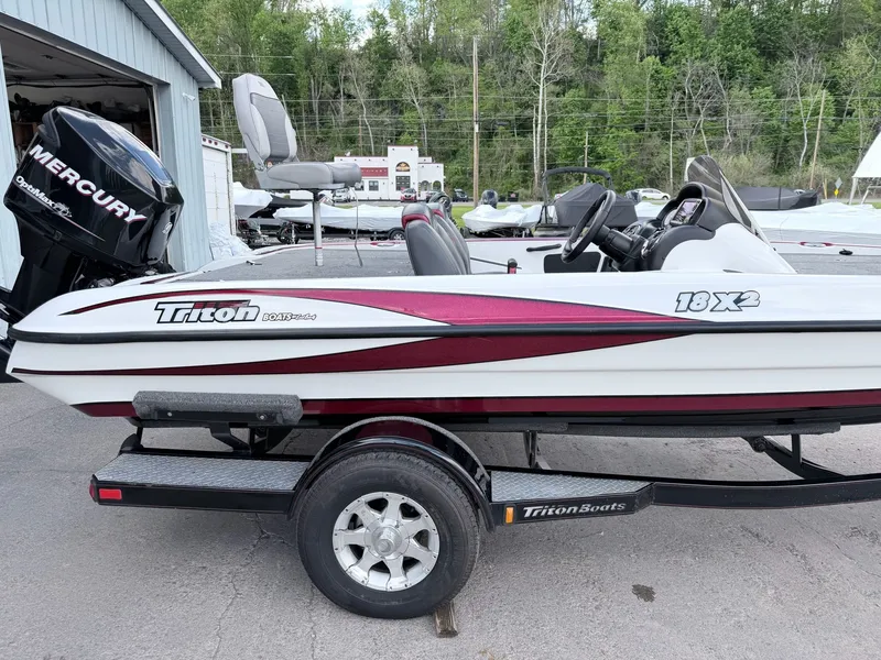 Slide: The Image of 2008 Triton 18X2 boat with Mercury engine, on trailer. - 23