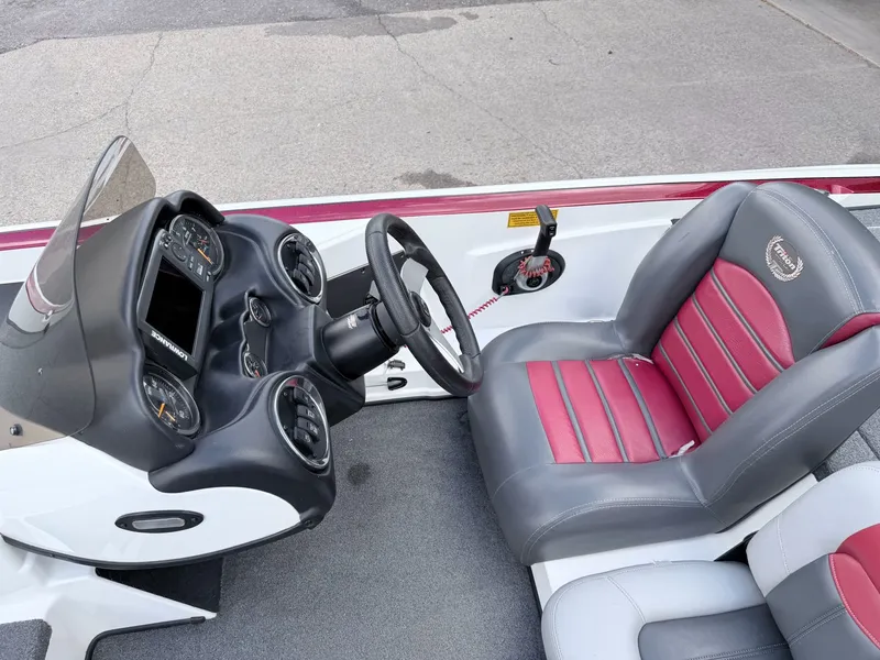 Slide: The Image of Interior of a 2008 Triton 18X2 boat with steering console and seat. - 24