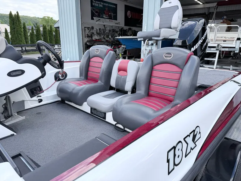 Slide: The Image of Interior of a 2008 Triton 18X2 boat with red seats. - 26